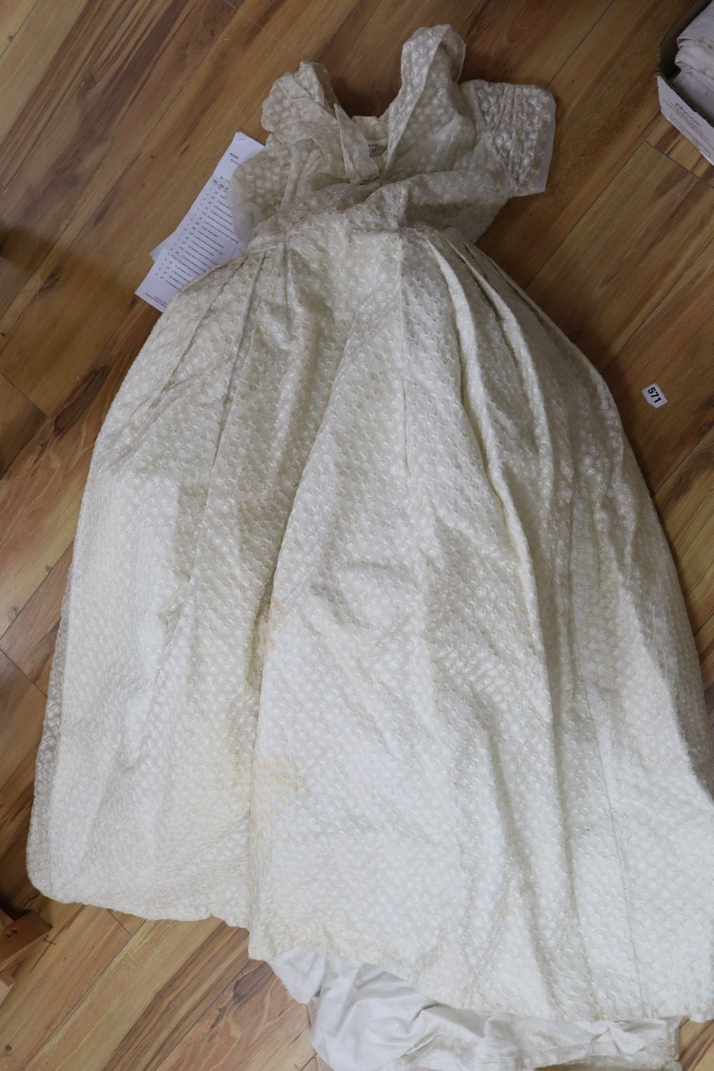A late 1940s / early 1950s off white embroidered wedding dress and a pair of satin shoes